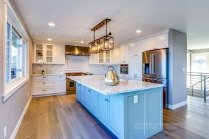 Baby blue and white cabinets with Calacatta tops